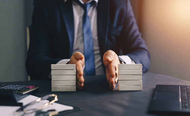Businessman separates wooden block to symbolize property division - concept of divorce and legal services
