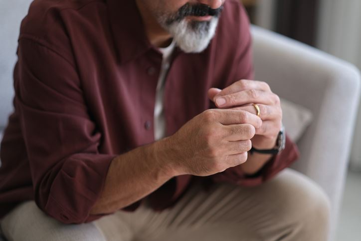 husband considering divorce while fiddling his wedding ring